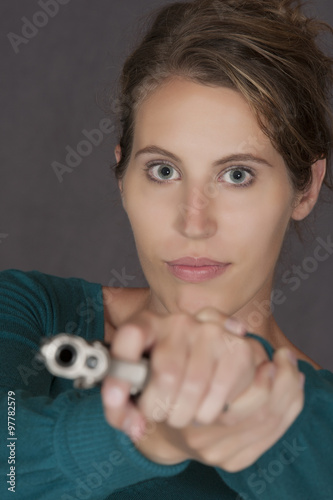 Caucasian woman defending herself using a handgun photo