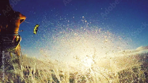 Extreme Kitesurfing at Sunset. Summer Ocean Sport in Slow Motion. Girl Kite Surfing in Bikini 