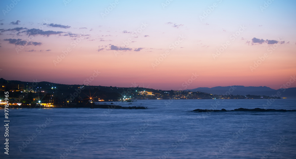Night view of coastline with houses.