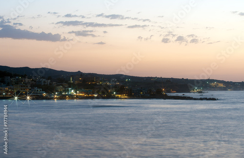 Night view of coastline with houses. © M-Production
