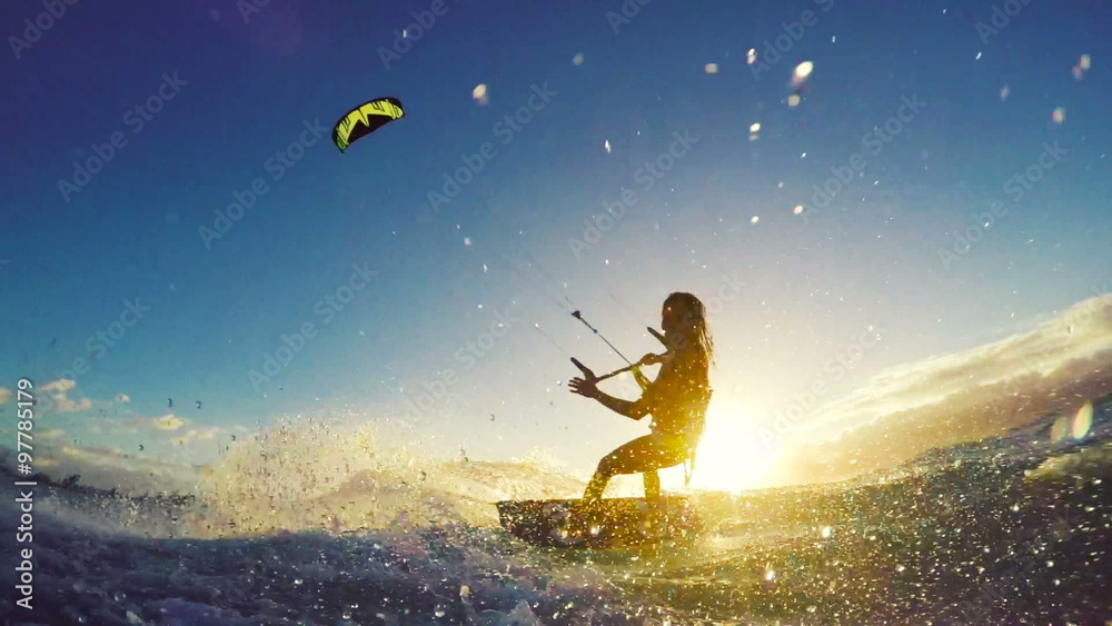 Extreme Kitesurfing at Sunset. Summer Ocean Sport in Slow Motion. Girl Kite Surfing in Bikini 