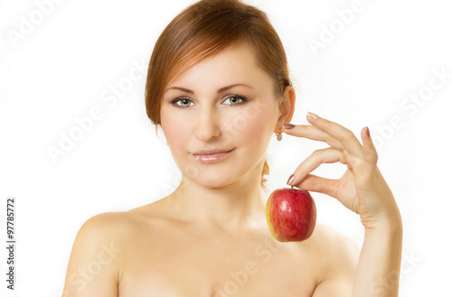 the young woman holds apple in hand