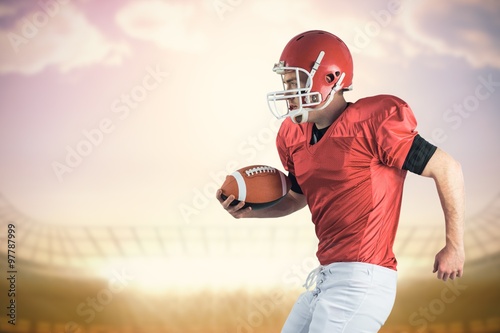 Composite image of american football player playing football