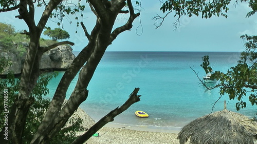 Scenic beach in curacao with inflatable boat in water near the beach.