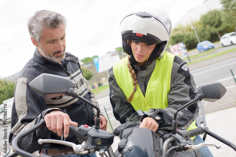 woman getting motorbike lesson