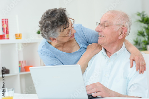 Elderly lady embracing husband