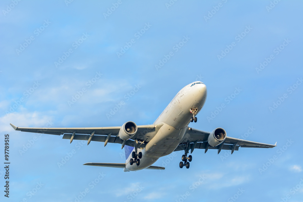 Airplane is flying to the runway from the airport during a cloudy day.