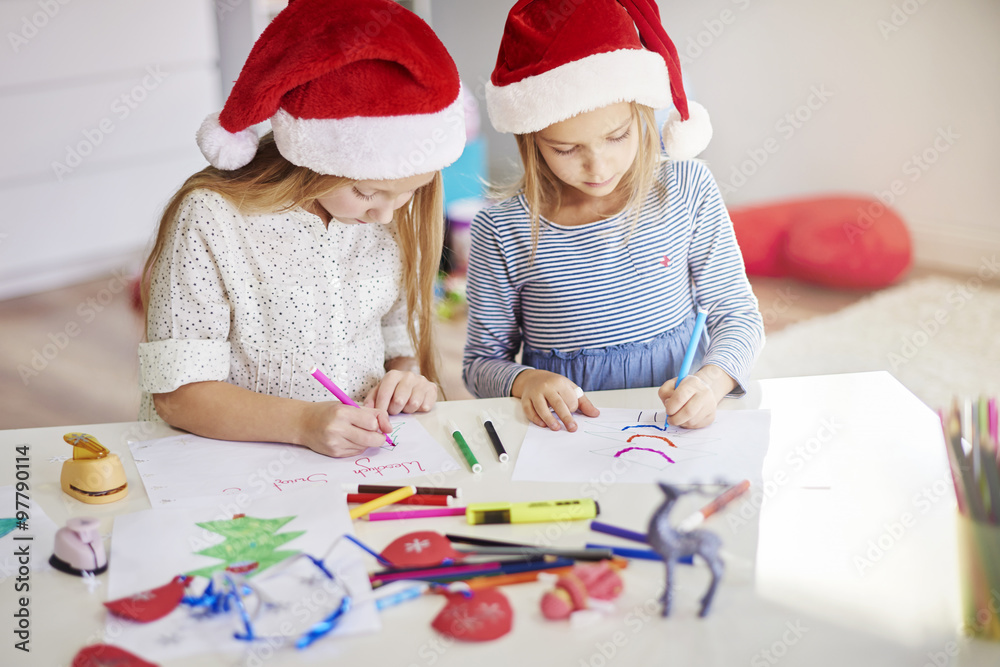 Pensive girls drawing christmas paintings Pensive girls drawing christmas paintings