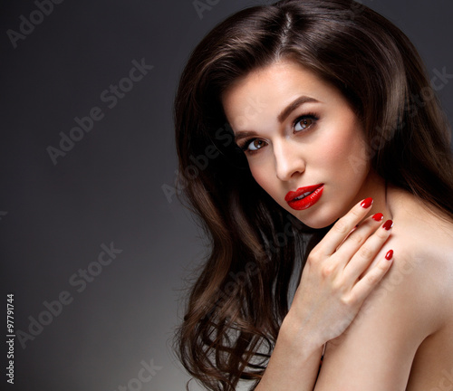 Beauty Model Woman with Long Brown Wavy Hair. Red Lips and Smoky Eyes Make up. Haircare, Skincare concept