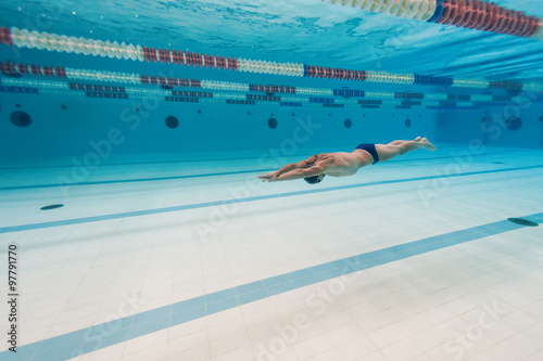 Professional man swimmer inside swimming pool.