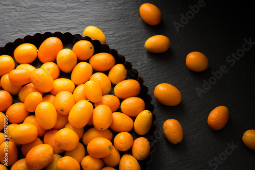 Kumquats on a Plate on a Table Top View