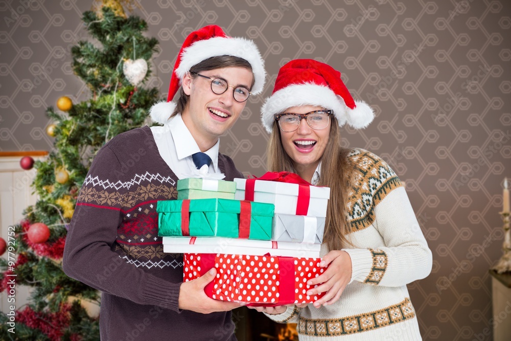 Composite image of smiling man and woman wearing santa hat Composite image of smiling man and woman wearing santa hat