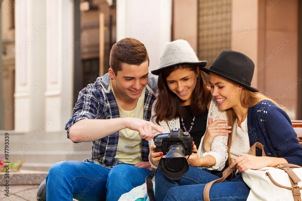 © Sergey Novikov - Guy and girl with camera sitting on the bench © Sergey Novikov - Guy and girl with camera sitting on the bench