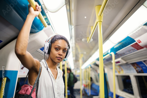 Photography Young woman portrait inside underground in London listening to music