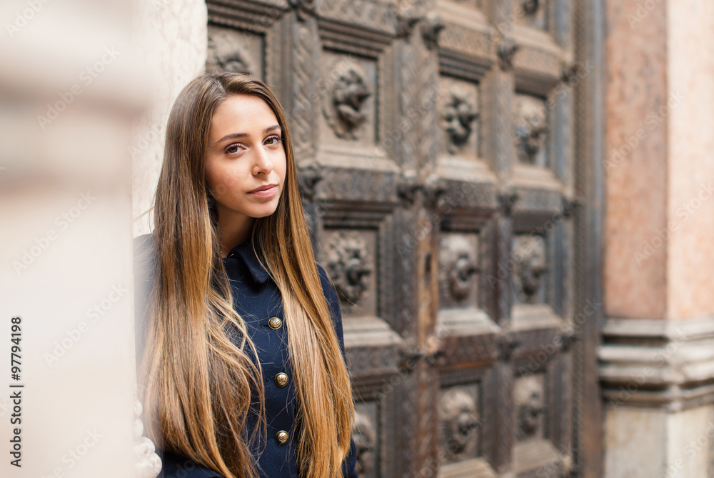 Fototapeta premium Portrait of young blonde woman walking in the street. Parma, Ita