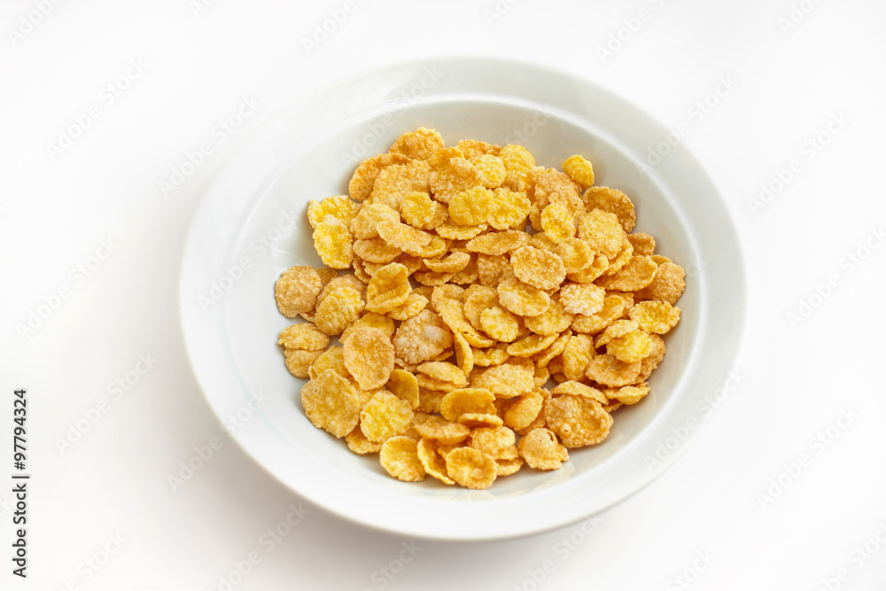 Plate of cornflakes isolated on white background. Plate of cornflakes isolated on white background.