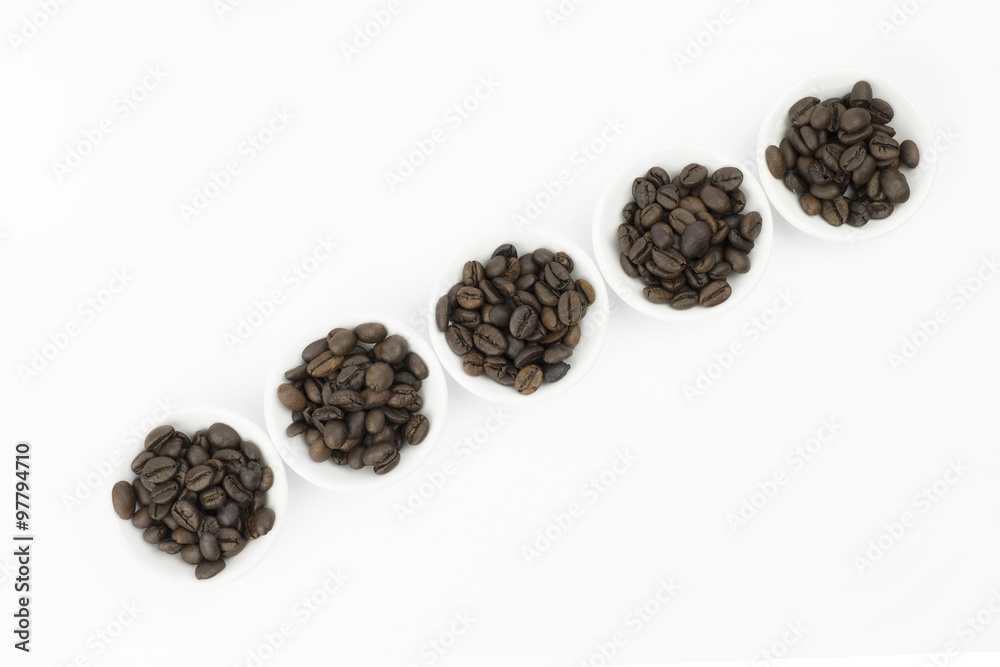 Coffee beans in white bowl on white background isolated Coffee beans in white bowl on white background isolated