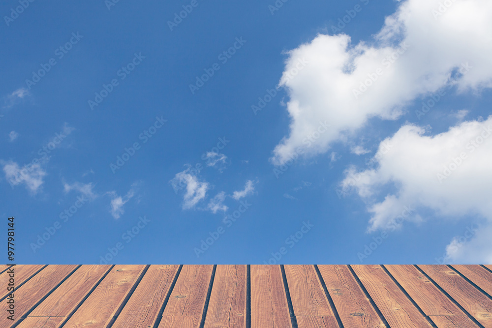 Brown natural wood flooring and blue sky background