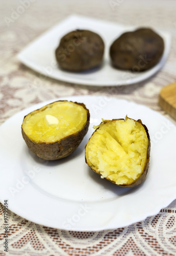 Baked potatoes cut into halves on the table