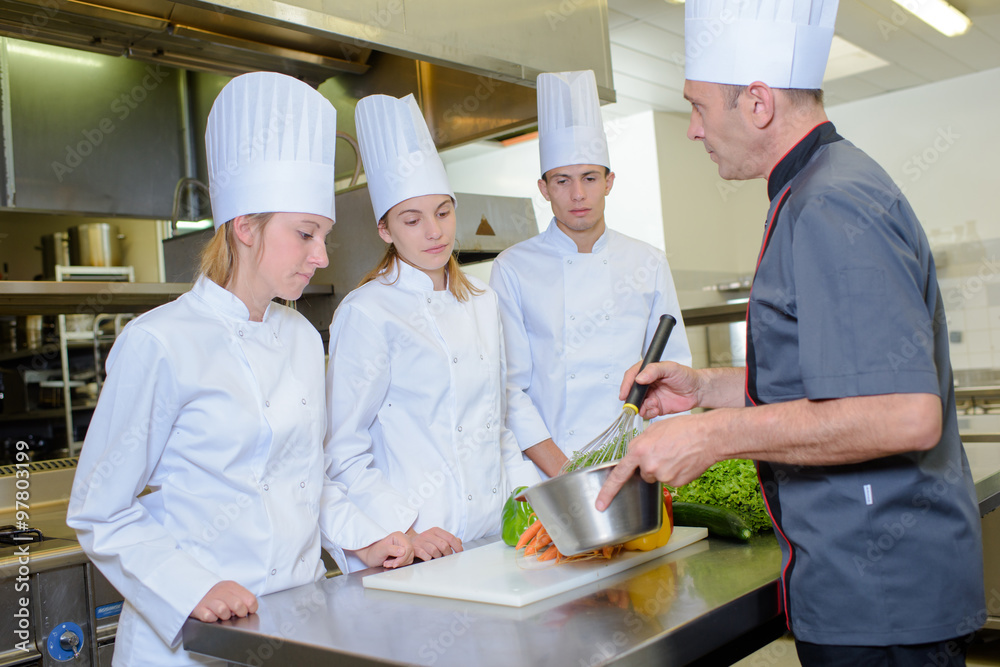 Cooking lesson with three apprentices