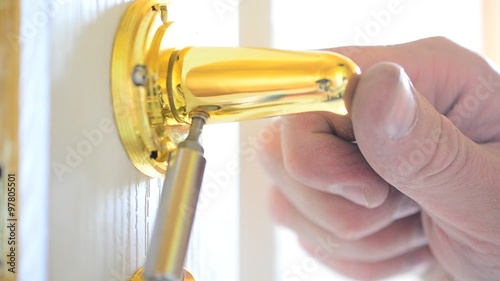 Mounting a mortise door lock. Fastening door handle screw photo