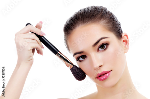 Pretty woman with makeup brush, isolated on white