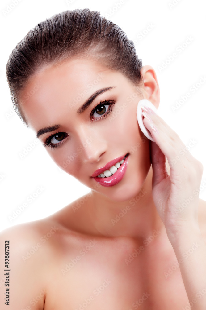 Beautiful woman using a cotton pad, isolated on white Beautiful woman using a cotton pad, isolated on white