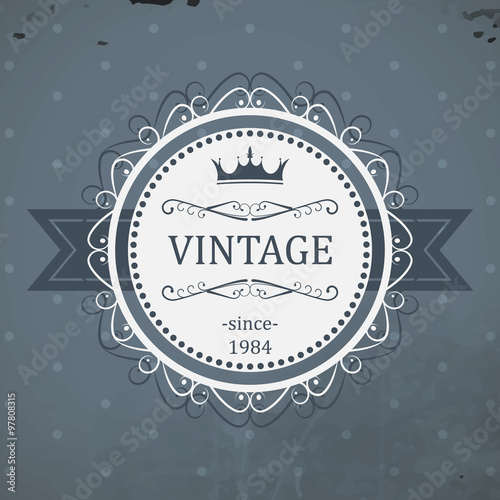 Round vintage label with ribbon, royal crown and grunge background. Vector illustration.