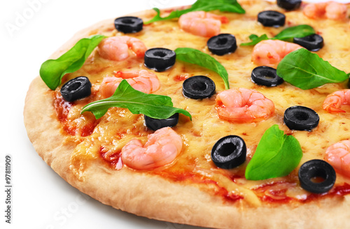 Pizza with shrimp olives and arugula on a white background.