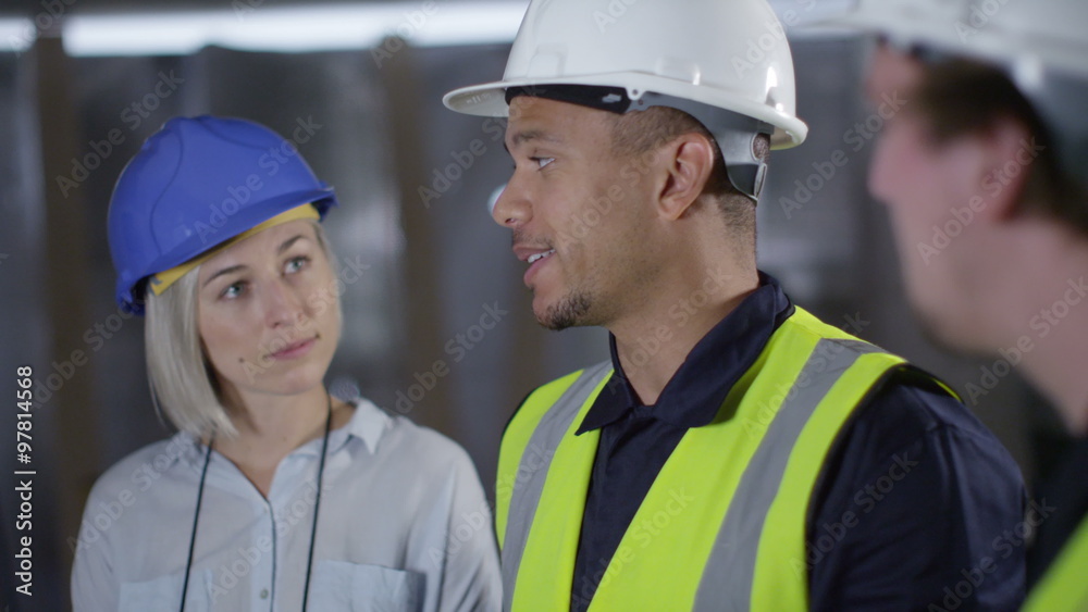 Confident female engineer or architect discussing construction issues with male colleagues. Confident female engineer or architect discussing construction issues with male colleagues.