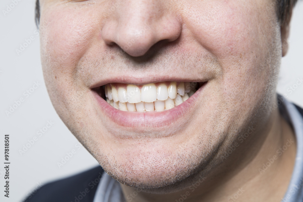Dark-haired european businessman shows us his perfect grin while in front of a gradient background Dark-haired european businessman shows us his perfect grin while in front of a gradient background