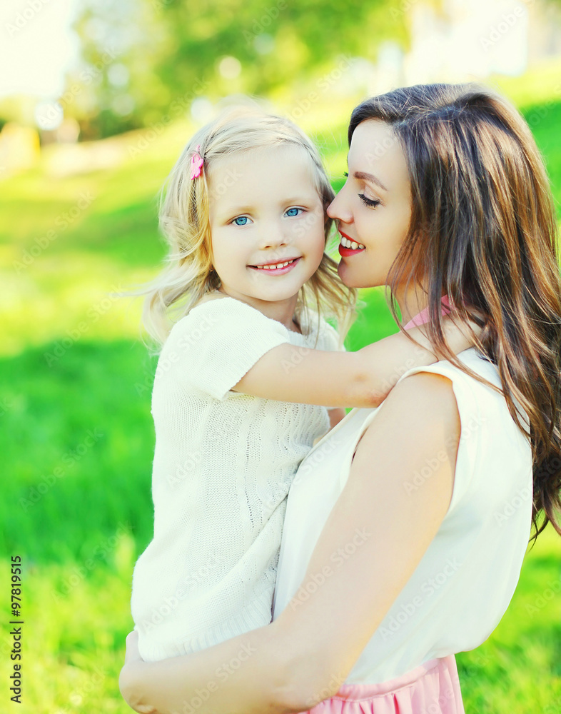 Portrait happy mother hugging child daughter in summer day