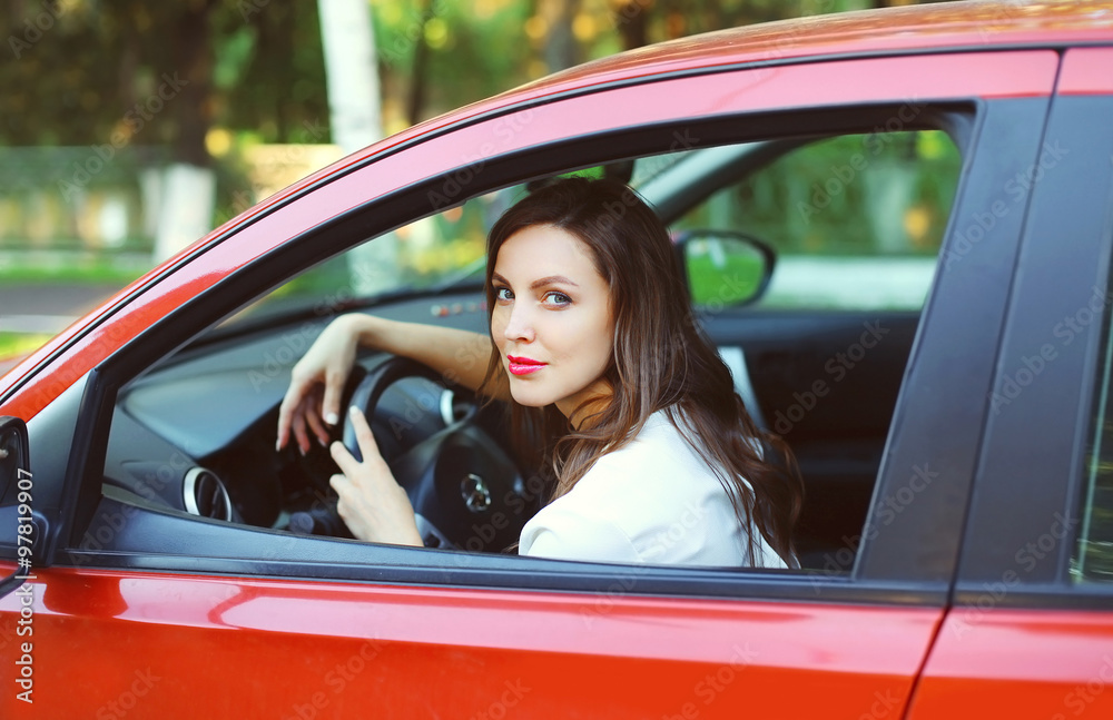Young beautiful woman driver behind the wheel red car Young beautiful woman driver behind the wheel red car