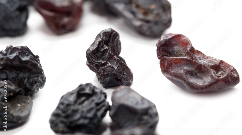Black raisins on a white background. macro Black raisins on a white background. macro
