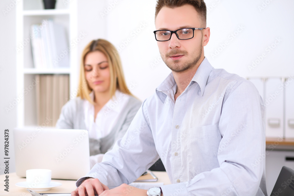 Successful businesspeople working at meeting in office. Businessman looking at camera. Start up business concept. Successful businesspeople working at meeting in office. Businessman looking at camera. Start up business concept.