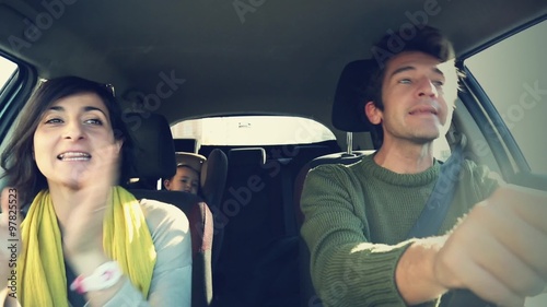 Happy loving family inside a car, singing a song