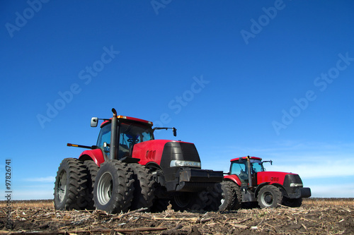 Two tractor cultivating the land