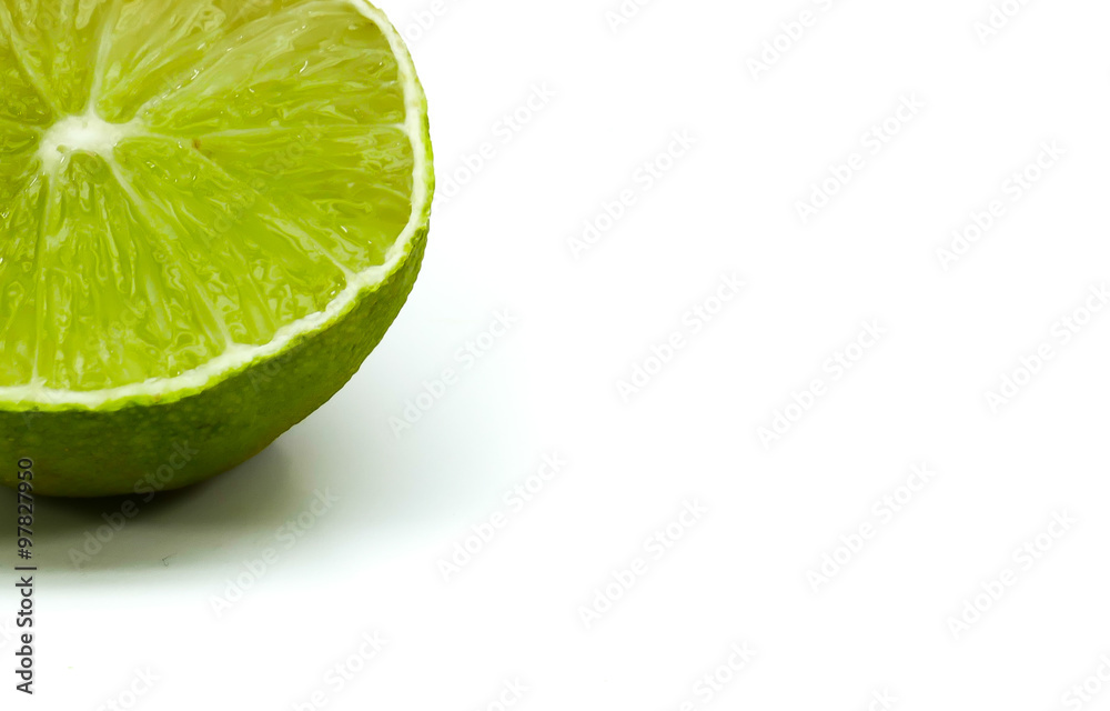 Cut in half green lemon isolated on white background