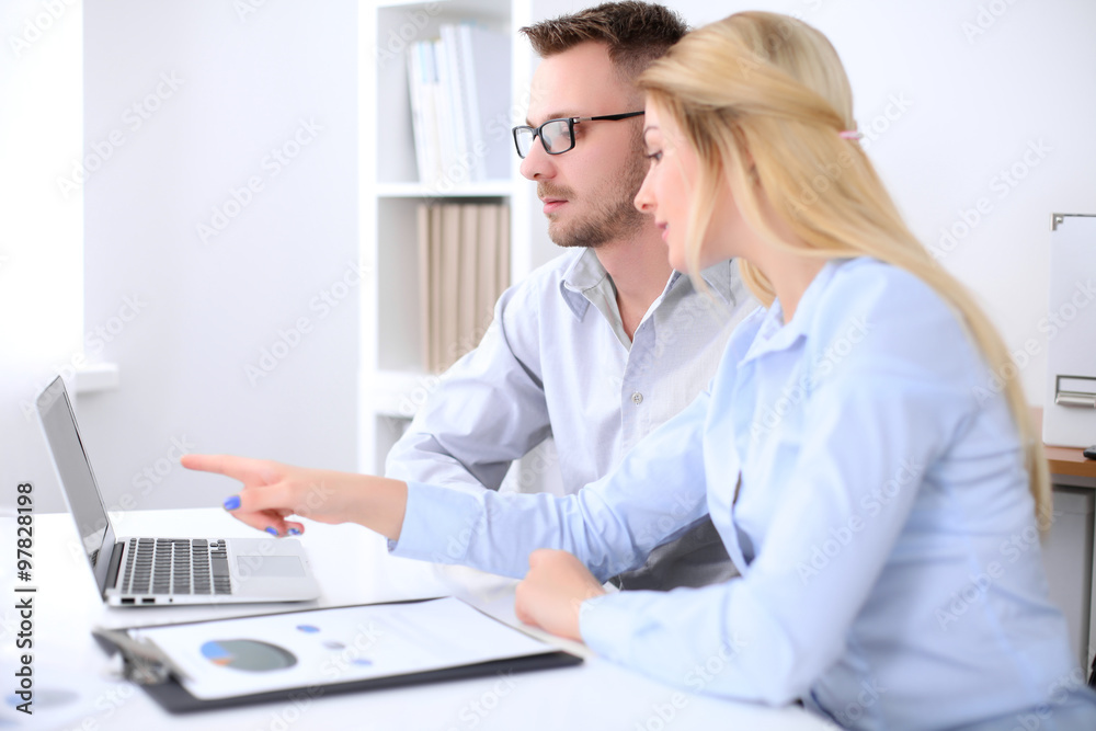 Two successful business partners working at meeting in office Two successful business partners working at meeting in office