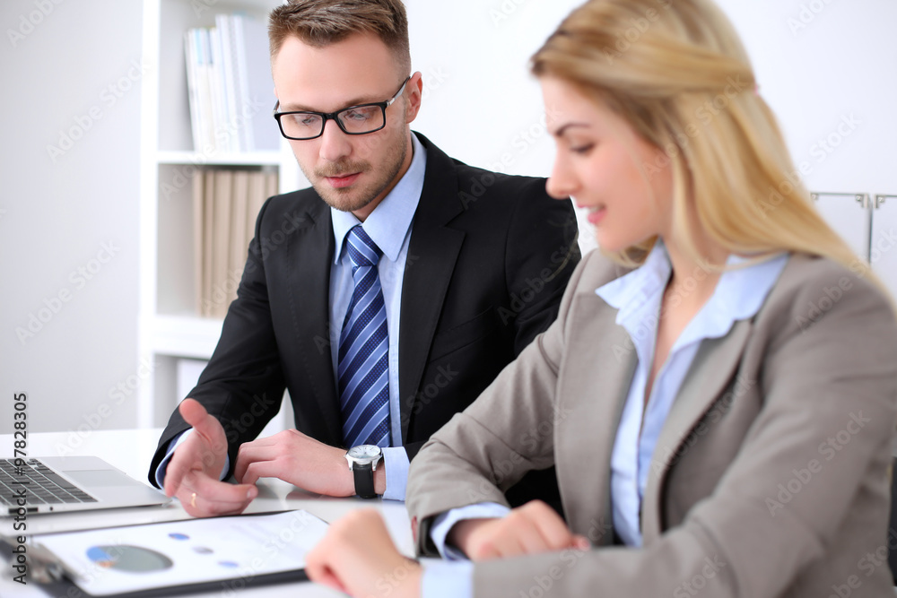 Two successful business partners working at meeting in office Two successful business partners working at meeting in office