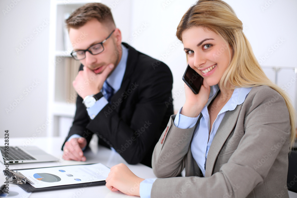 Two successful business partners working at meeting in office Two successful business partners working at meeting in office