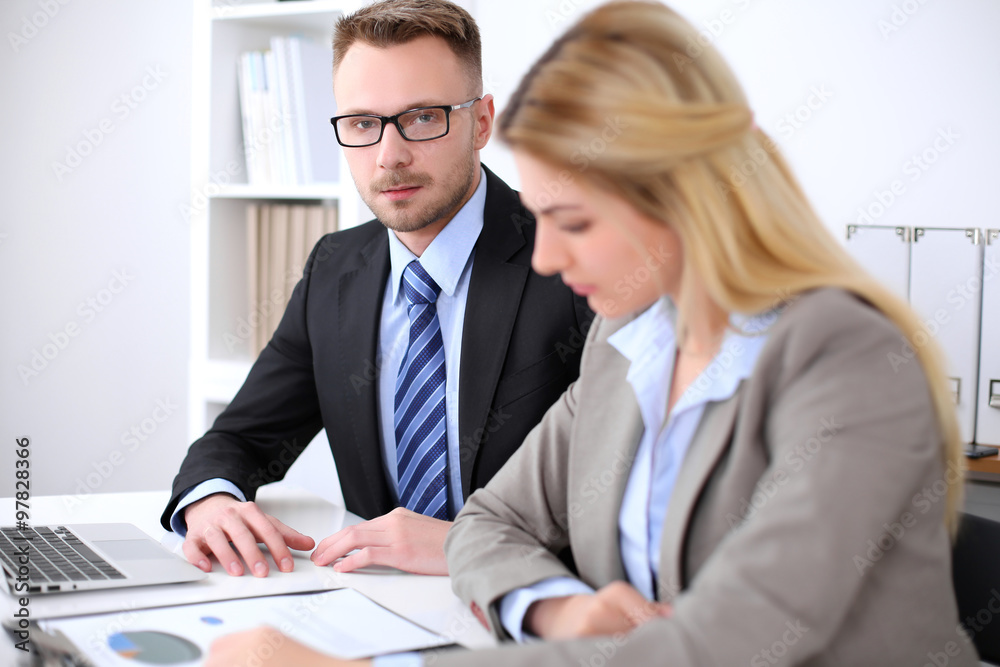 Two successful business partners working at meeting in office Two successful business partners working at meeting in office