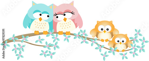 Cute owl family on spring tree branch