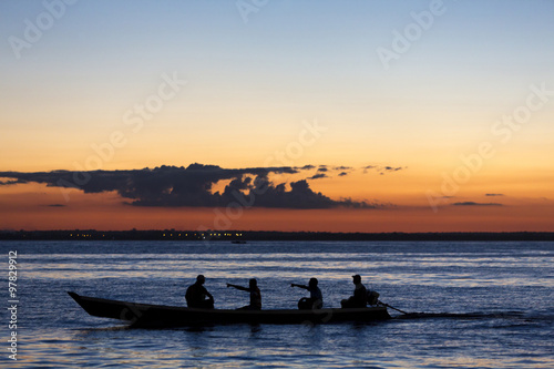 Sunset and silhouettes on boat cruising the Amazon River, Brazil © piccaya