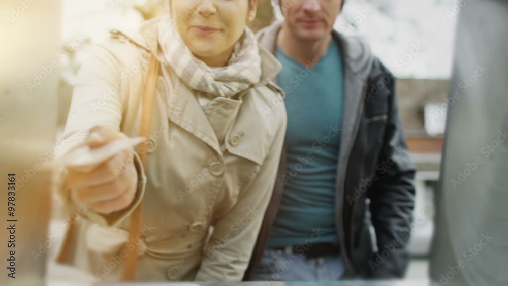 Cheerful couple taking money from ATM machine Cheerful couple taking money from ATM machine
