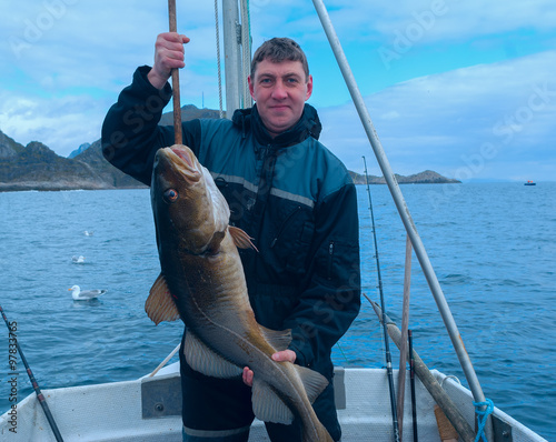 Fisherman on the boat with codfish