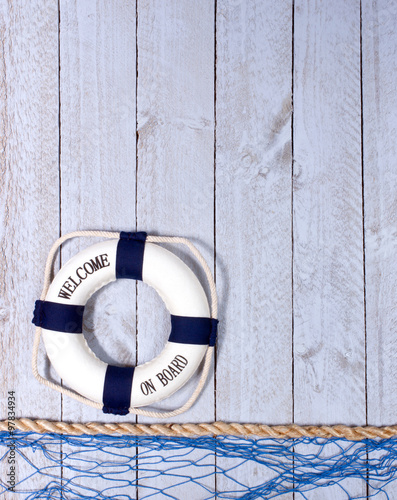 Fototapeta Welcome on Board - lifebuoy on wooden background, copyspace for individual text