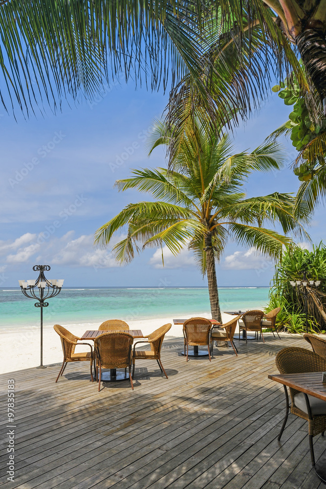 Restaurant on tropical beach next blue ocean