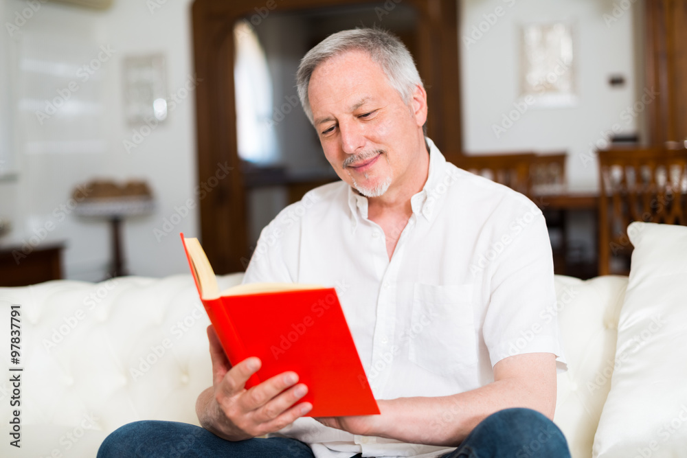 Happy mature man reading a book Happy mature man reading a book