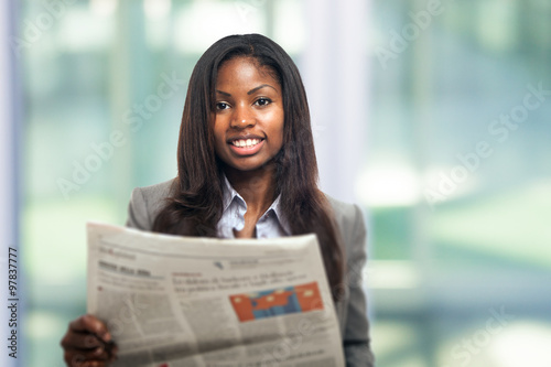 Business woman reading a newspaper photo